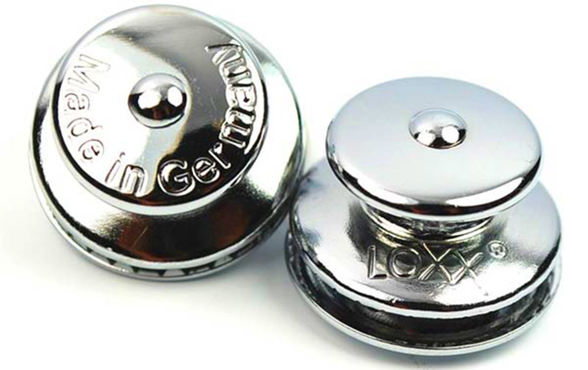 Two chrome Loxx snap fasteners made in Germany on white background